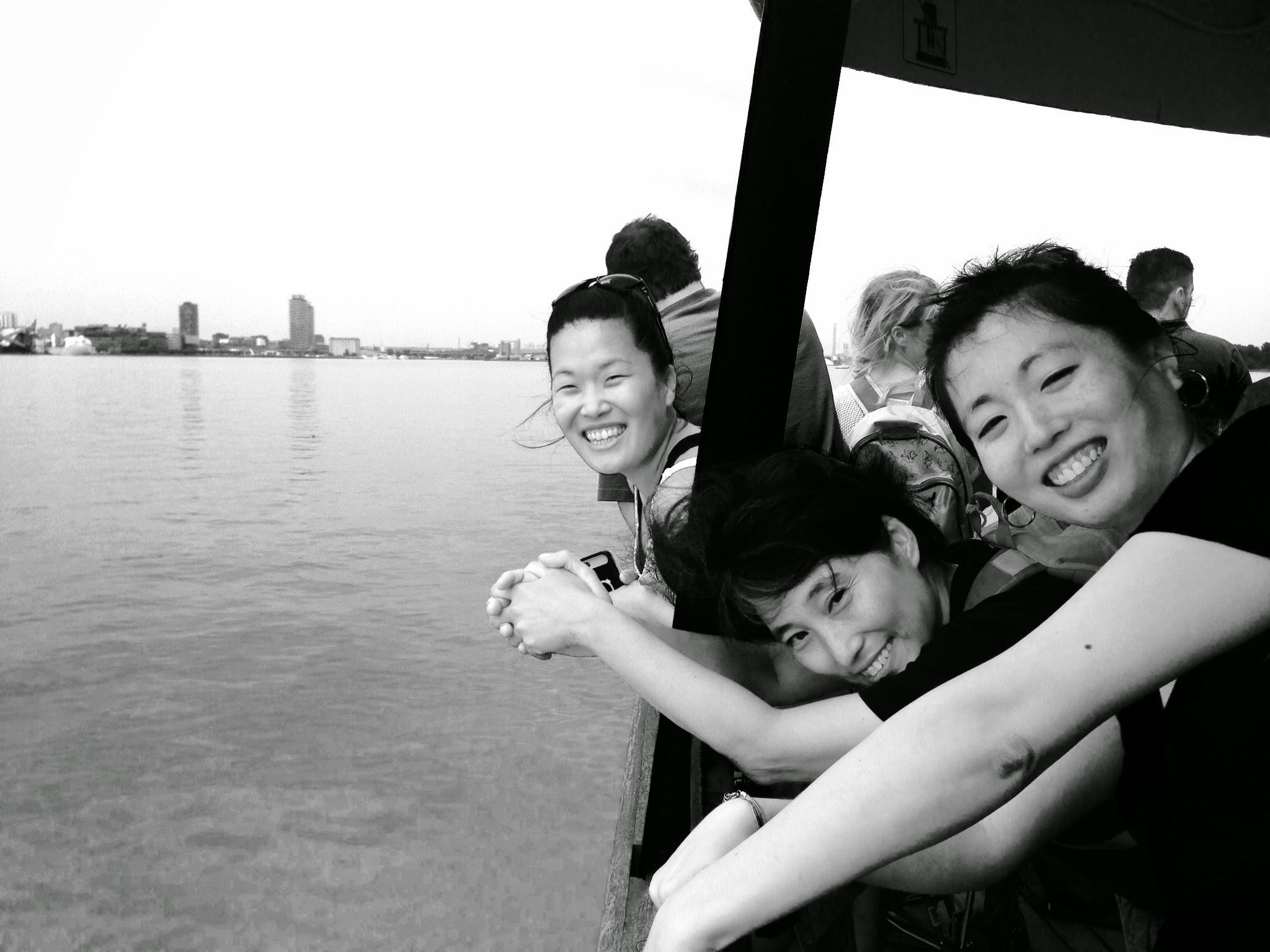Three Korean women on a boat, looking into the camera, smiling. Hyun is in the middle.